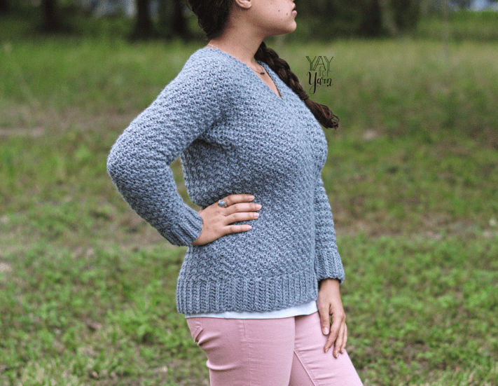 girl wearing grey crochet sweater with pink pants