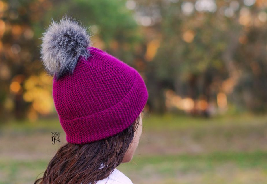 side view, burgundy purple toque beanie hat with pom pom