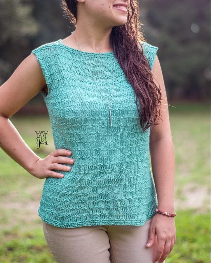 girl wearing lightly textured soft blue-green summer top with hand on hip