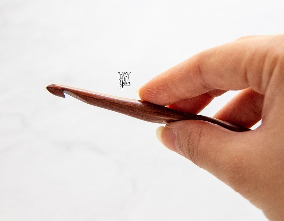 hand holding laurel hill wooden crochet hook