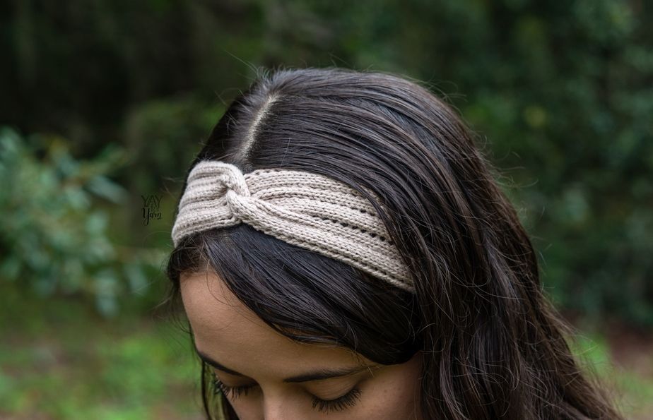 front / side view of twisted knit headband with eyelets