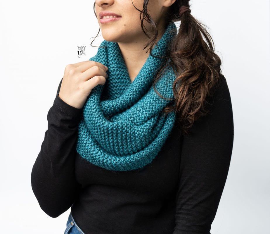 girl wearing black long sleeve tee shirt with teal blue infinity scarf